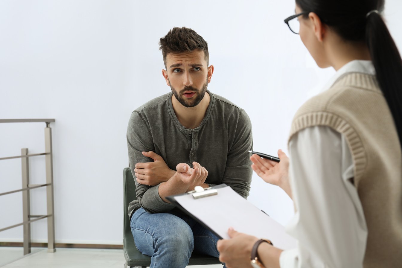 Psychotherapist Working with Drug Addicted Man Indoors